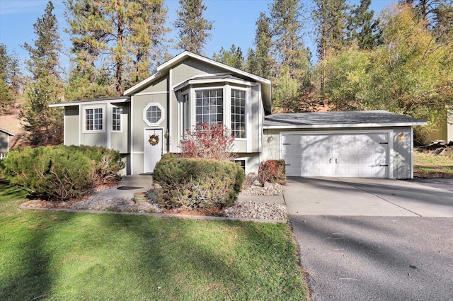 129 E Wynot Dr, Nine Mile Falls, WA 99026 - bi-level home with a garage, a front lawn, and concrete driveway