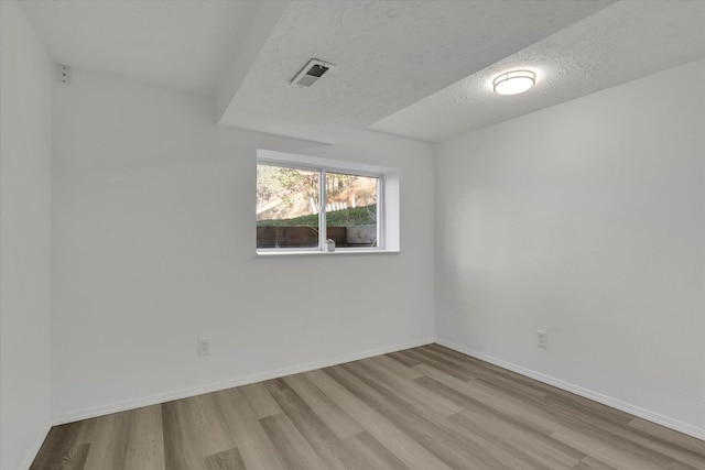 129 E Wynot Dr, Nine Mile Falls, WA 99026 - unfurnished room with visible vents, a textured ceiling, baseboards, and wood finished floors