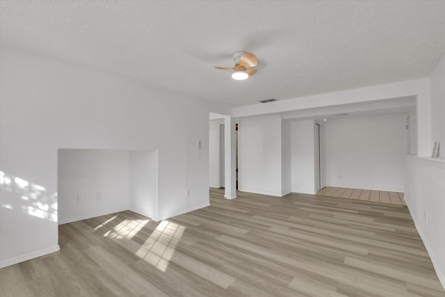 129 E Wynot Dr, Nine Mile Falls, WA 99026 - spare room featuring a textured ceiling, visible vents, baseboards, and light wood finished floors