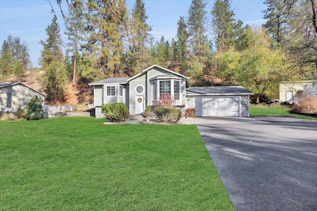 129 E Wynot Dr, Nine Mile Falls, WA 99026 - view of front of house with aphalt driveway, a front yard, and a garage