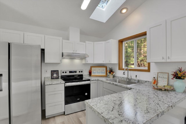 129 E Wynot Dr, Nine Mile Falls, WA 99026 - kitchen featuring a sink, vaulted ceiling with skylight, electric stove, freestanding refrigerator, and under cabinet range hood