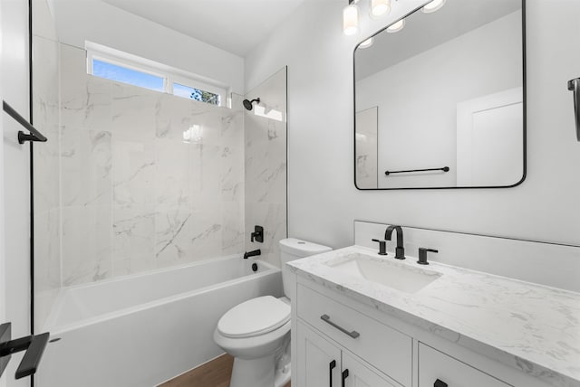 bathroom with vanity, washtub / shower combination, toilet, and wood finished floors