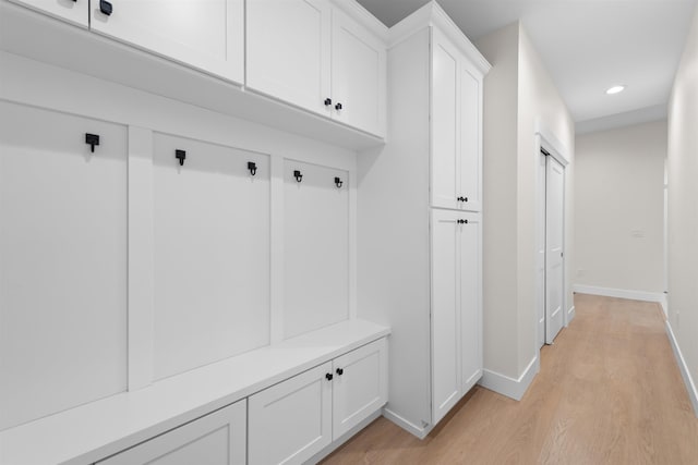 mudroom with light wood-style floors, baseboards, and recessed lighting