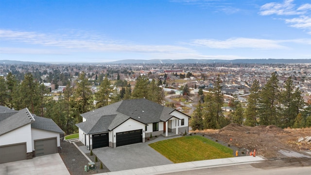 drone / aerial view featuring a residential view and a mountain view