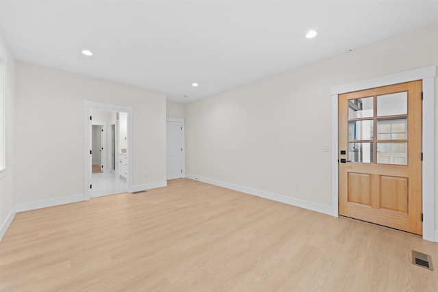 unfurnished room with visible vents, recessed lighting, light wood-style floors, and baseboards
