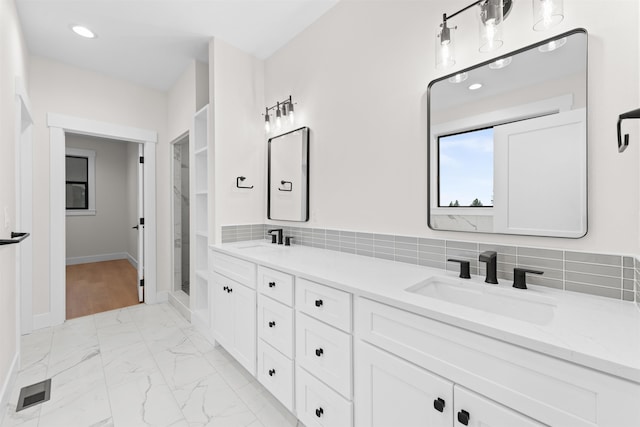full bath featuring a sink, recessed lighting, double vanity, and marble finish floor