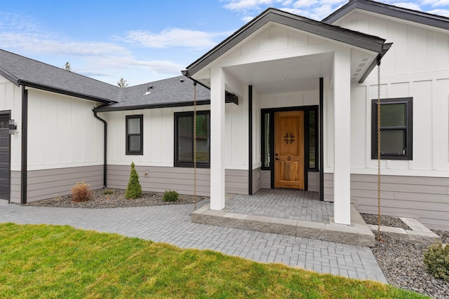 view of exterior entry featuring board and batten siding