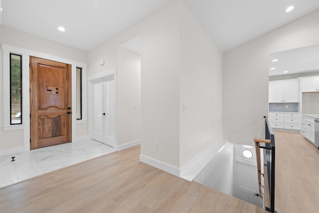 entryway featuring recessed lighting, baseboards, and marble finish floor
