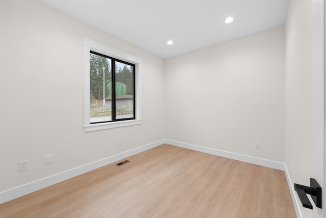 unfurnished room featuring recessed lighting, baseboards, visible vents, and light wood finished floors