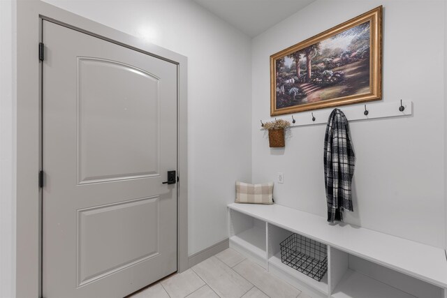 mudroom featuring baseboards and light tile patterned floors