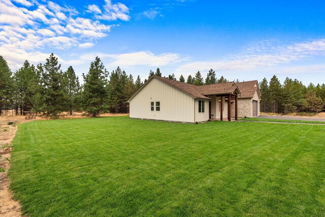 exterior space featuring a lawn and an attached garage