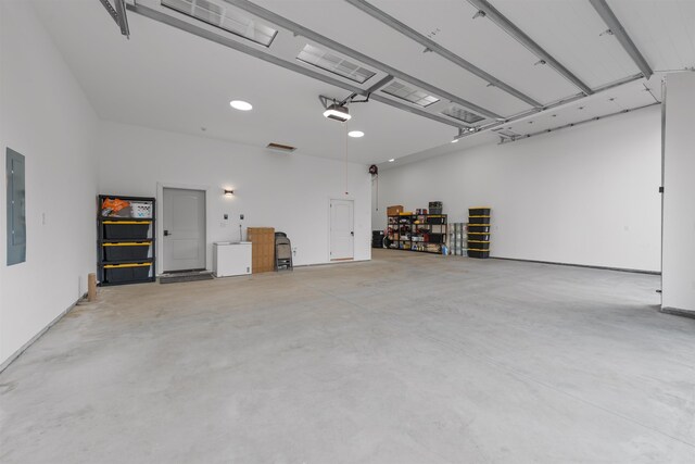 garage featuring a garage door opener and electric panel