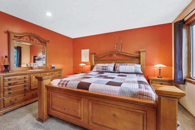 bedroom with light carpet and recessed lighting