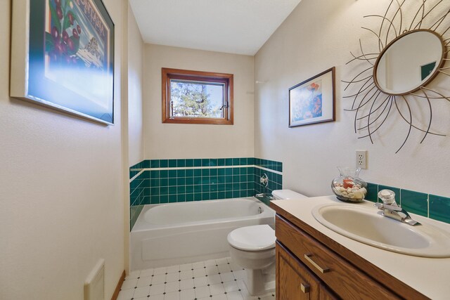 bathroom featuring tile patterned floors, vanity, toilet, and a bath