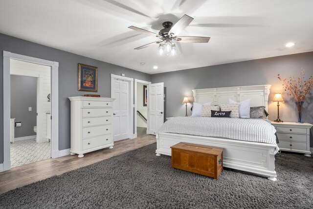 bedroom with carpet floors, recessed lighting, baseboards, and wood finished floors