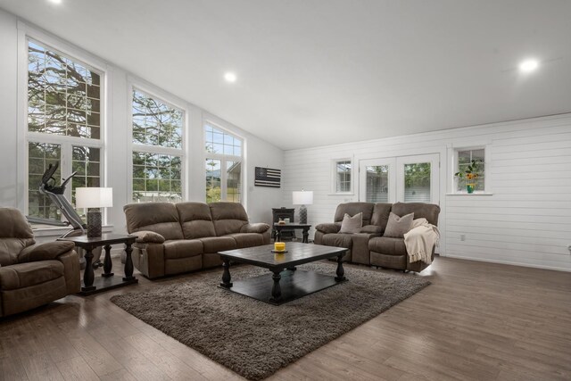 living area with wooden walls, recessed lighting, wood finished floors, and lofted ceiling