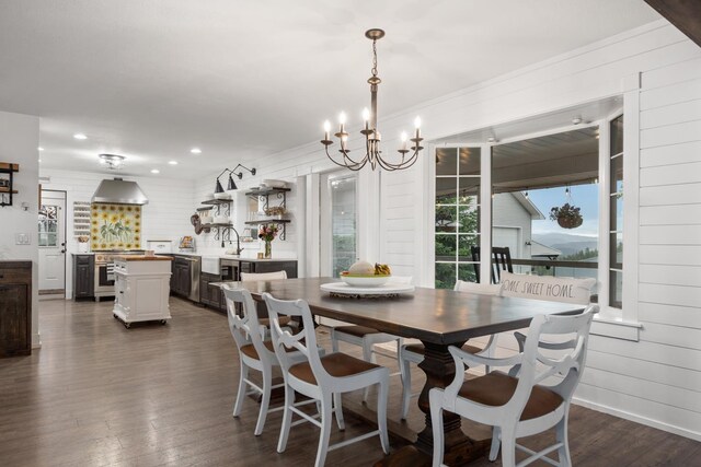 dining space with an inviting chandelier, recessed lighting, and dark wood-style flooring