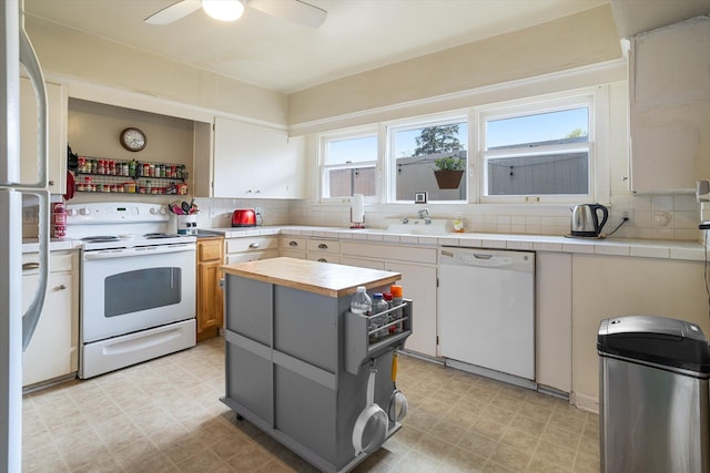 3314 E 29th Ave, Spokane, WA 99223 - kitchen with light floors, decorative backsplash, a ceiling fan, and white appliances