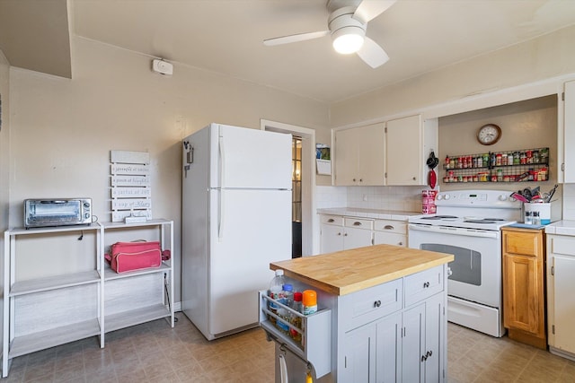 3314 E 29th Ave, Spokane, WA 99223 - kitchen featuring ceiling fan, a toaster, white cabinets, white appliances, and butcher block countertops