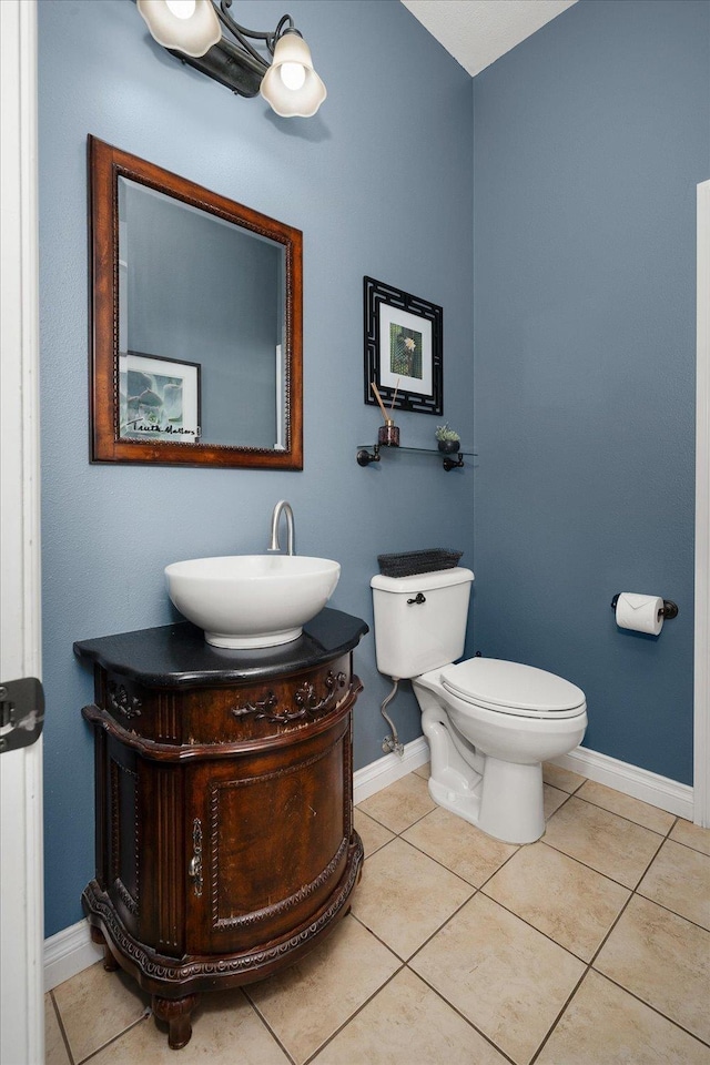 22828 S Gateway Ln, Cheney, WA 99004 - bathroom with baseboards, tile patterned floors, toilet, and vanity