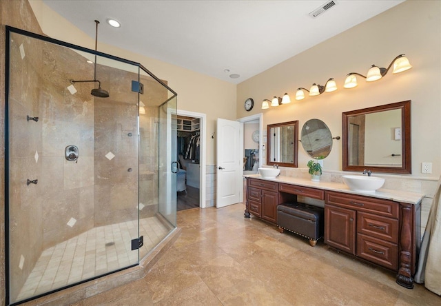 22828 S Gateway Ln, Cheney, WA 99004 - full bath featuring double vanity, visible vents, a sink, and a stall shower