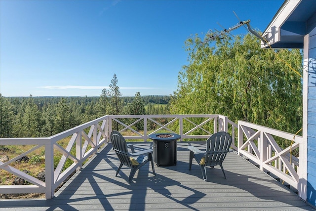 22828 S Gateway Ln, Cheney, WA 99004 - wooden deck featuring a view of trees and a fire pit