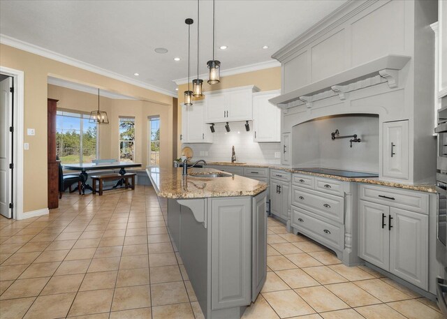 22828 S Gateway Ln, Cheney, WA 99004 - kitchen with ornamental molding, black electric stovetop, light tile patterned floors, a sink, and backsplash