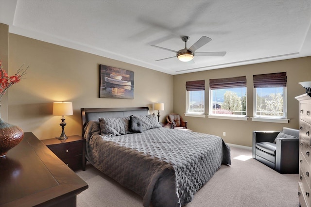 carpeted bedroom with baseboards and a ceiling fan