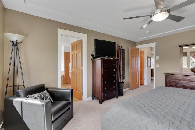 bedroom with baseboards, ceiling fan, light carpet, and connected bathroom