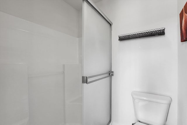 full bathroom with a shower stall and toilet