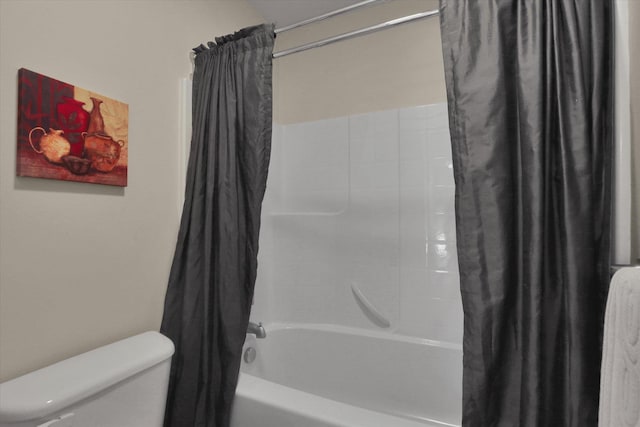 bathroom with shower / tub combo with curtain and toilet