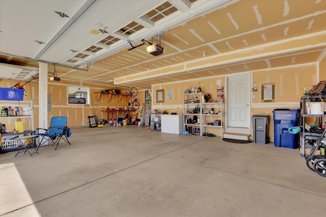 garage featuring a garage door opener and electric panel