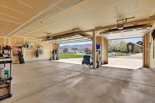 garage with a garage door opener and a mountain view