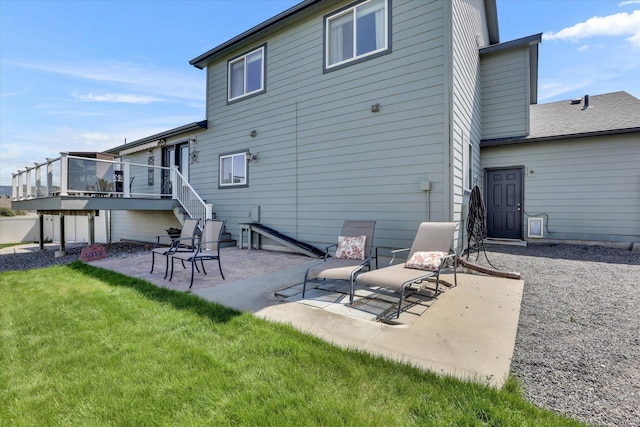 back of property with a patio, stairway, a lawn, and a deck