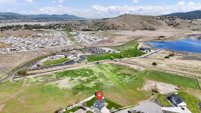 drone / aerial view with a water and mountain view