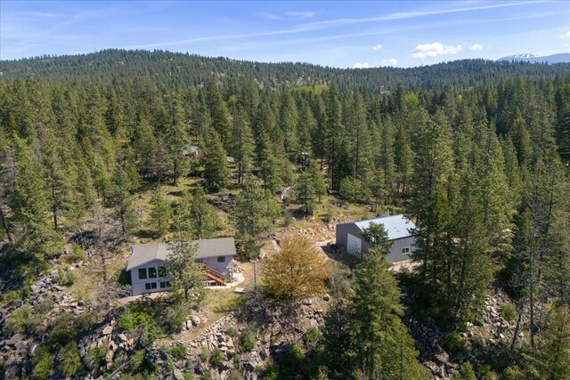 drone / aerial view featuring a view of trees