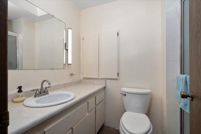 bathroom featuring toilet and vanity