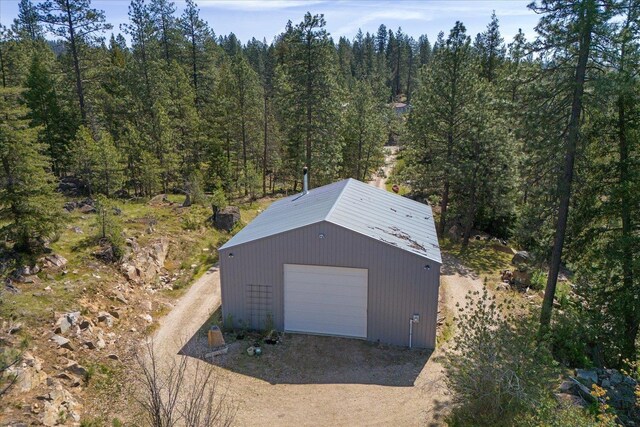 drone / aerial view featuring a wooded view