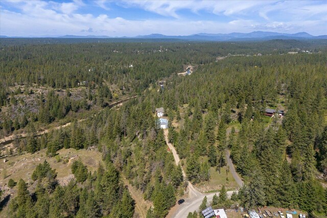 birds eye view of property with a view of trees and a mountain view