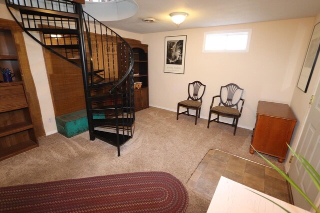 sitting room with baseboards, carpet, and stairway