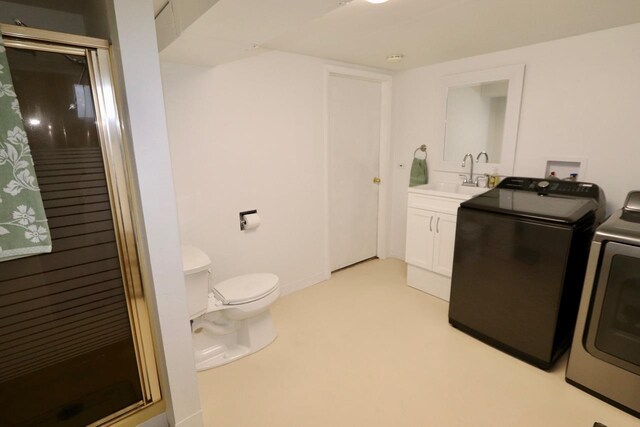 clothes washing area featuring laundry area, a sink, and washer and clothes dryer