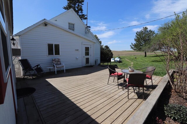 wooden terrace featuring a lawn
