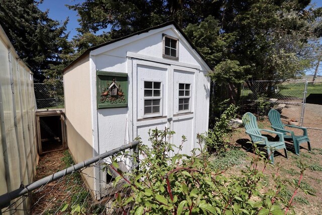 view of shed with fence