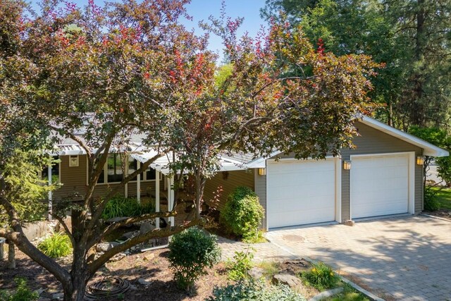 view of front facade with decorative driveway and an attached garage