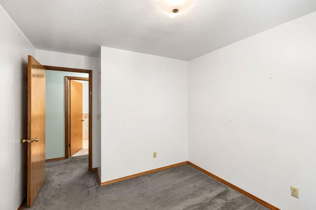 spare room with carpet floors and baseboards