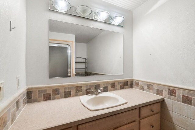 bathroom featuring tile walls and vanity