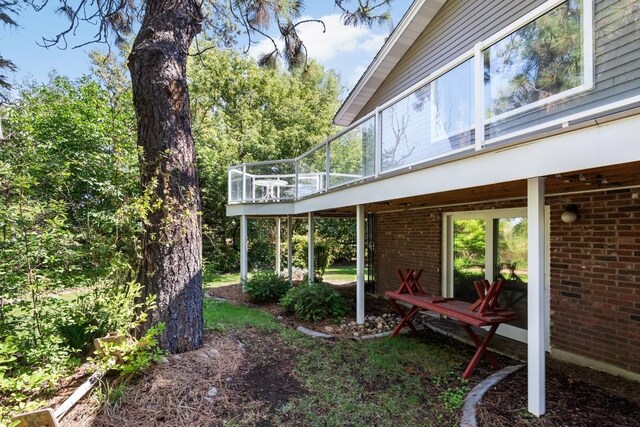 exterior space with brick siding and a wooden deck