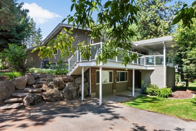 view of front of property with brick siding and stairs