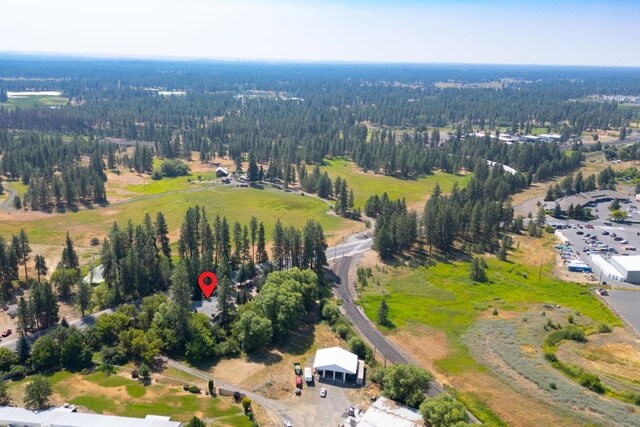 drone / aerial view with a wooded view