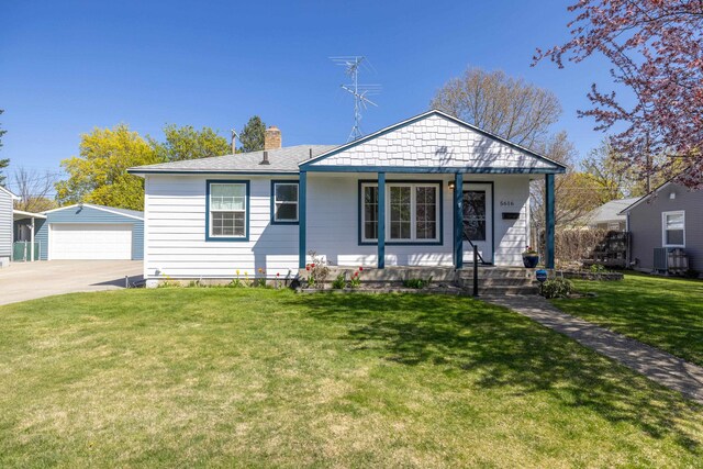 bungalow with a garage, a front yard, an outbuilding, a chimney, and covered porch